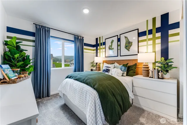 a bedroom with a large bed and a potted plant