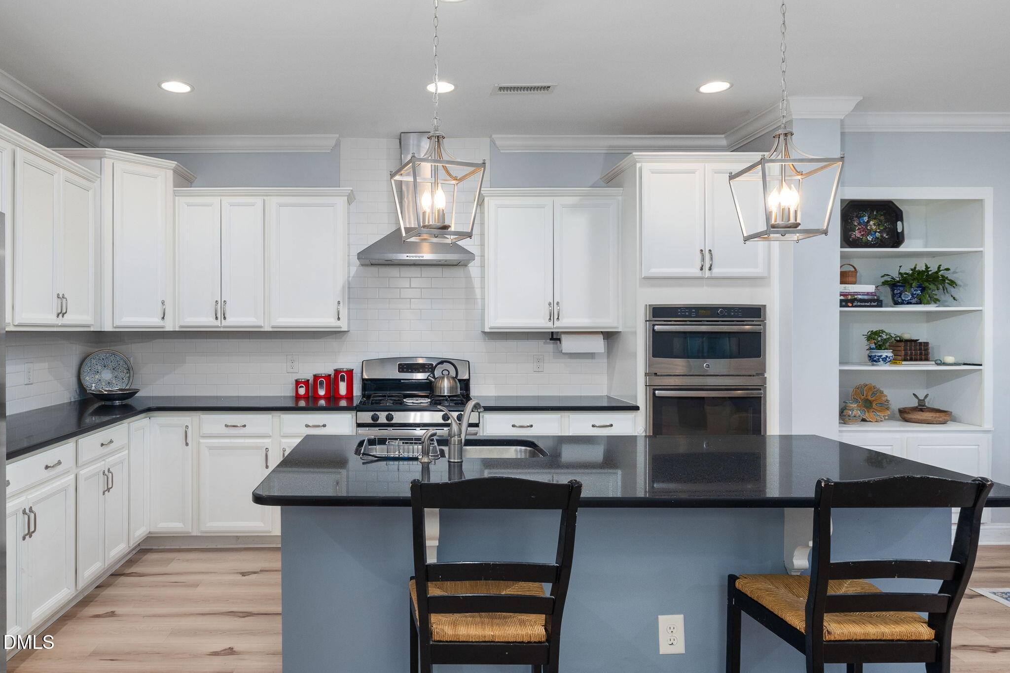 621 Fallon Grove Way Raleigh, NC 27608 - Photo 7 of 24 a kitchen with kitchen island granite countertop a sink cabinets and stainless steel appliances