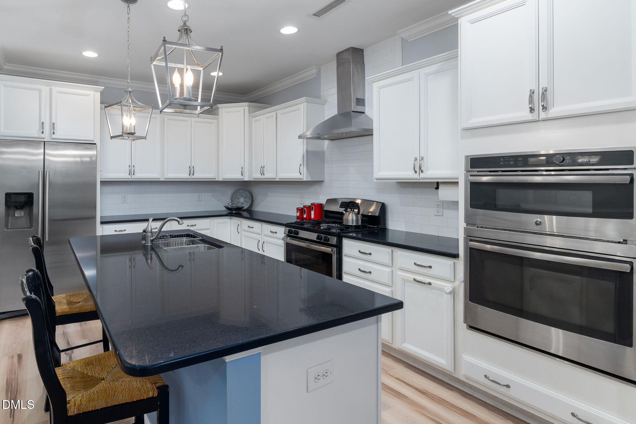 621 Fallon Grove Way Raleigh, NC 27608 - Photo 8 of 24 a kitchen with stainless steel appliances granite countertop a sink a stove and a refrigerator