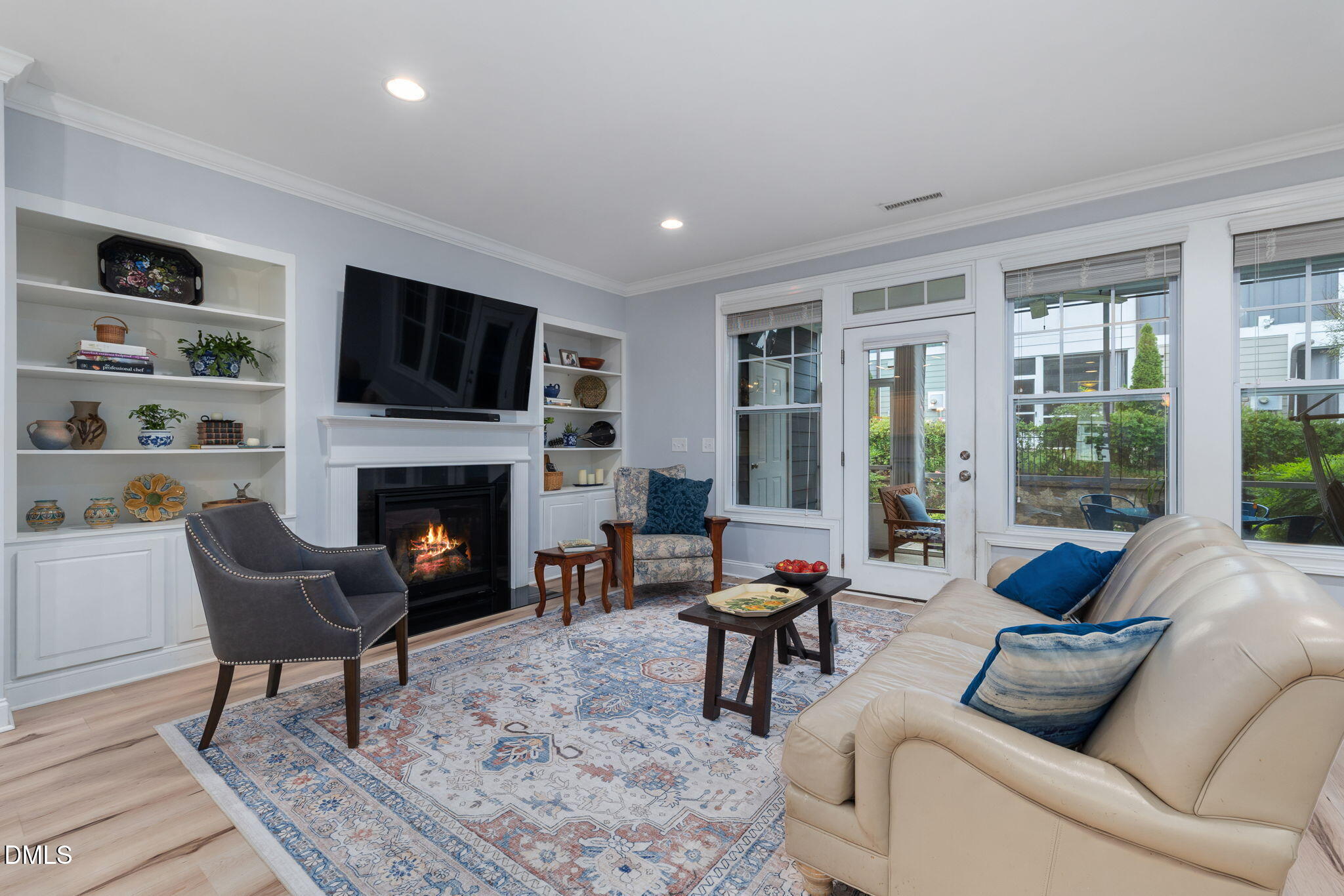 621 Fallon Grove Way Raleigh, NC 27608 - Photo 9 of 24 a living room with furniture a fireplace and a flat screen tv