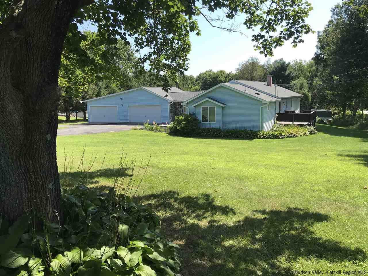 308 Forest Road Wallkill, NY 12589 - Photo 1 of 35 a yellow house with a big yard plants and large trees