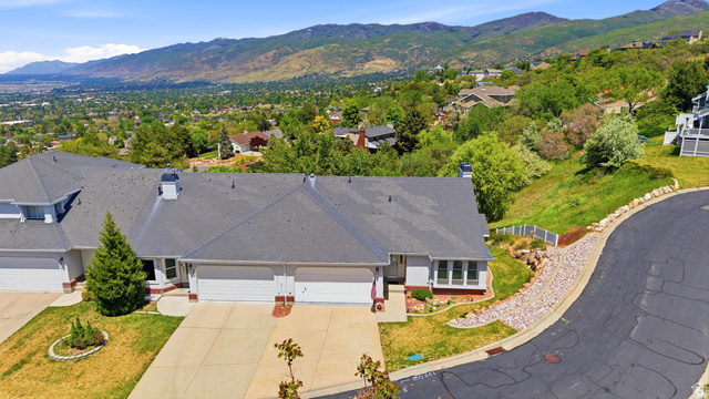 3766 Cardiff Circle Bountiful, UT 84010 - Photo 39 of 46 Traditional-style residence with a dark shingle roof, light-colored siding, and multiple garage doors