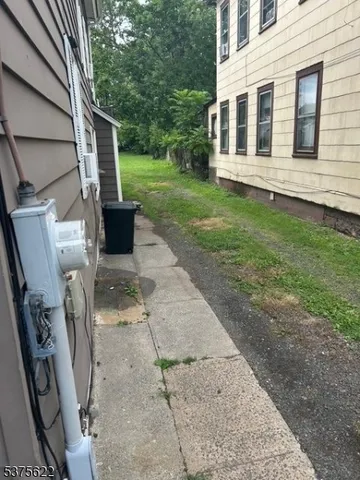 a view of a house with a backyard