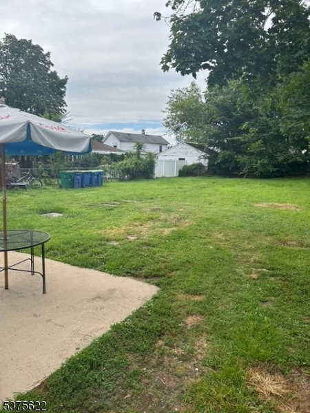 106 West Somerset Street Raritan, NJ 08869 - Photo 22 of 28 a view of a garden with lawn chairs and a large tree