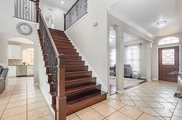 a view of an entryway with wooden floor