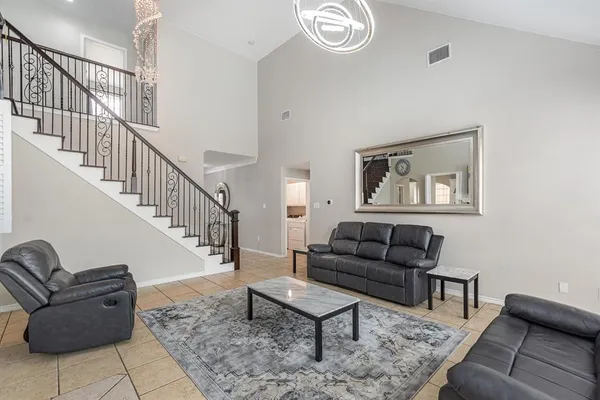 a living room with furniture and a rug
