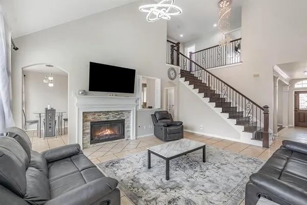 a living room with furniture a flat screen tv and a fireplace