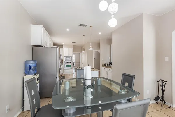 a view of kitchen with refrigerator and workspace