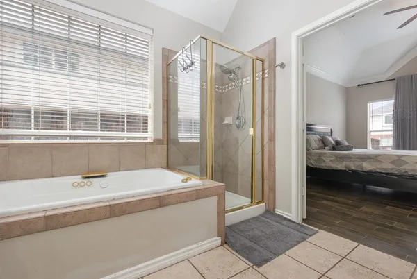 a en suite bathroom with a tub shower and sink