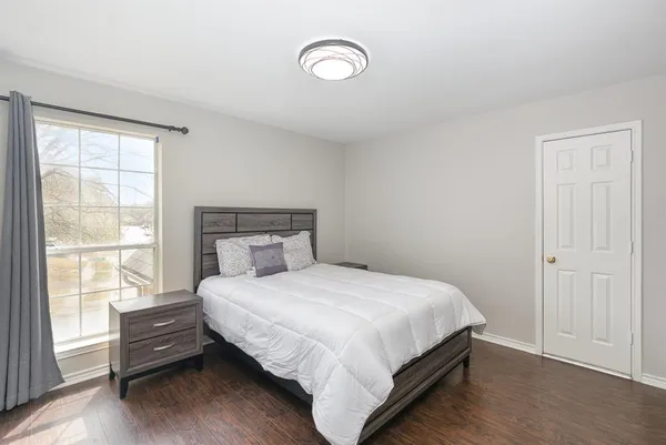 a bedroom with a bed and a window