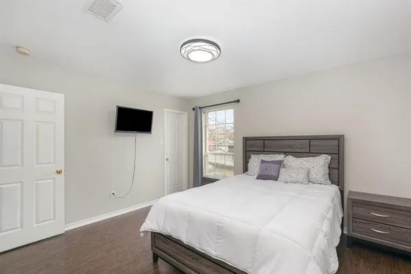 a bedroom with a bed and a tv