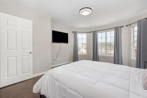 a bedroom with a bed and a flat screen tv