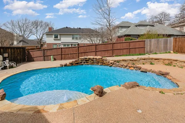 a view of a backyard with wooden fence