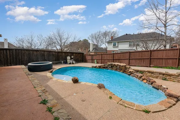 a view of a backyard with table and chairs with wooden fence