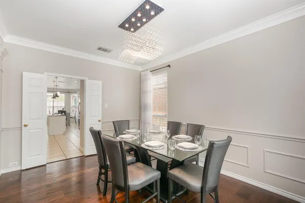 a view of a dining room with furniture and wooden floor