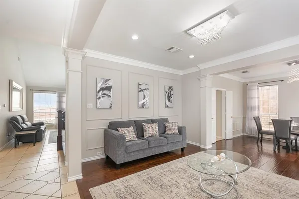 a living room with furniture and wooden floor