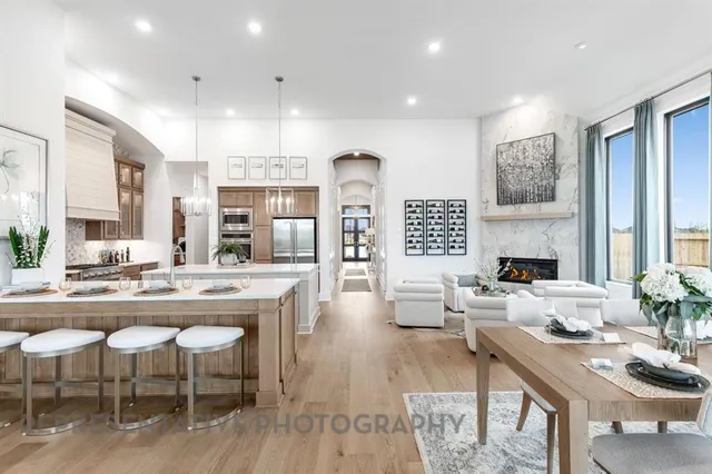 a living room with furniture and kitchen view