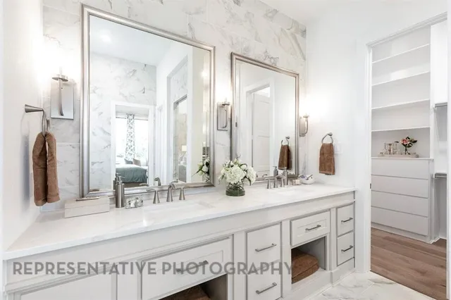 a spacious bathroom with a granite countertop tub sink and mirror