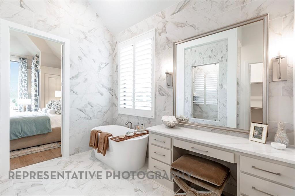 301 Short Cut Street Northlake, TX 76247 - Photo 8 of 14 a spacious bathroom with a granite countertop tub sink and mirror