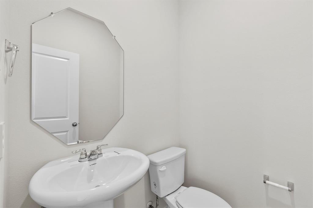 3416 Rendezvous Way Sherman, TX 75090 - Photo 14 of 24 a bathroom with a sink mirror and toilet