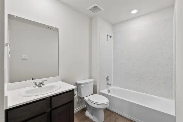 a bathroom with a sink toilet a mirror and shower