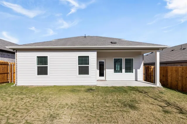 a front view of a house with glass windows and yard