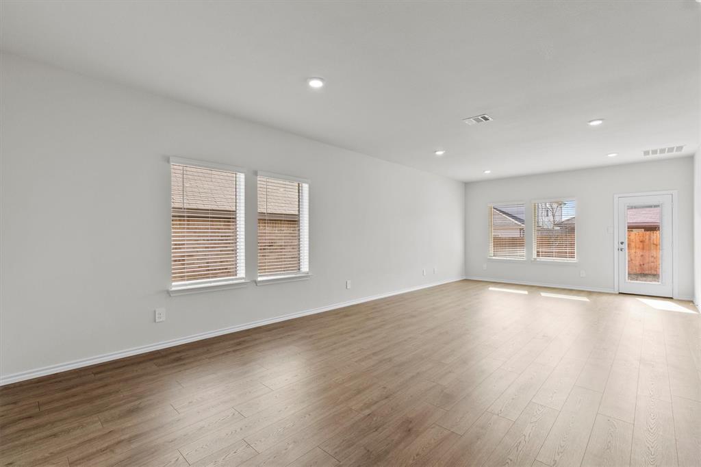 3416 Rendezvous Way Sherman, TX 75090 - Photo 5 of 24 a view of an empty room with wooden floor and a window