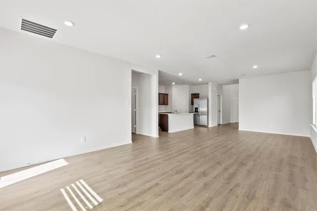 a view of kitchen with refrigerator and a sink