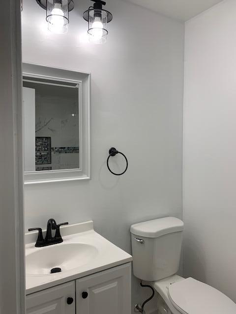 851 150th Street Hammond, IN 46327 - Photo 10 of 13 a bathroom with a toilet a sink and mirror