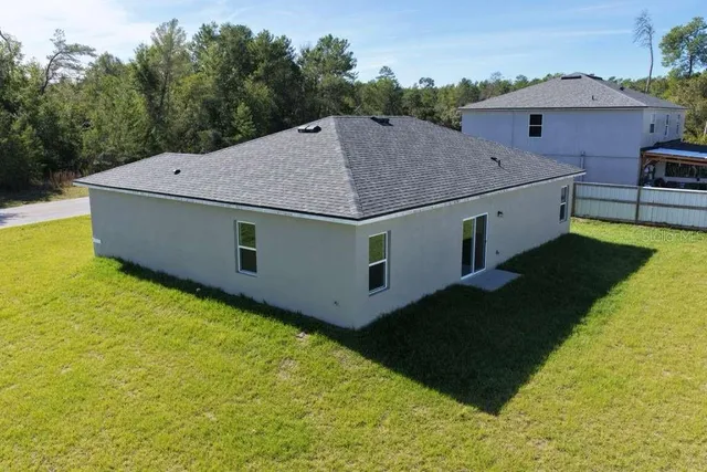 a aerial view of a house with a yard