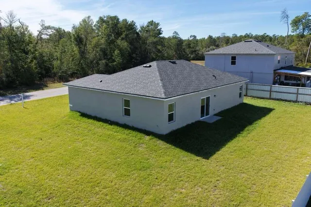 a view of a house with pool and yard