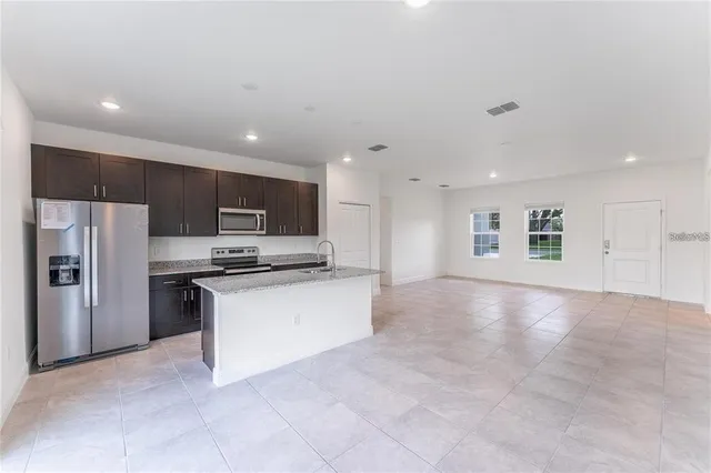a view of kitchen with refrigerator sink and microwave
