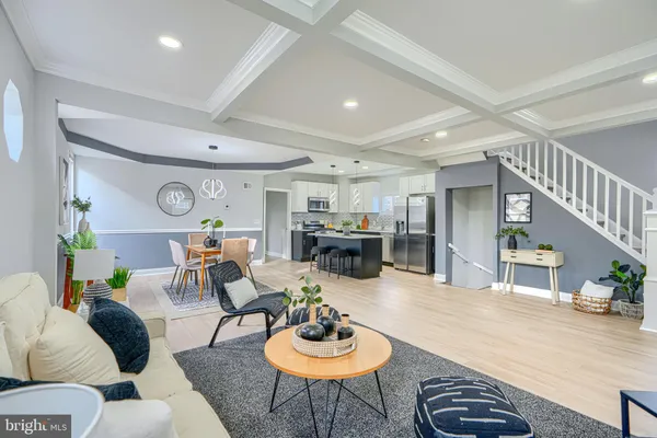 a living room with furniture kitchen and a window