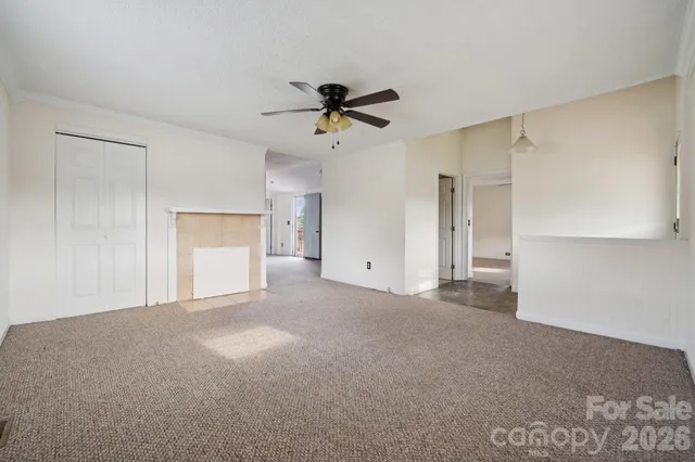 a view of a big room with carpet and windows