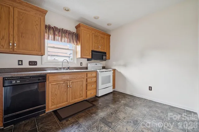 a kitchen with a sink stove and microwave