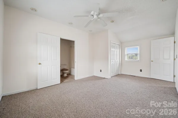 a view of an empty room with a ceiling fan