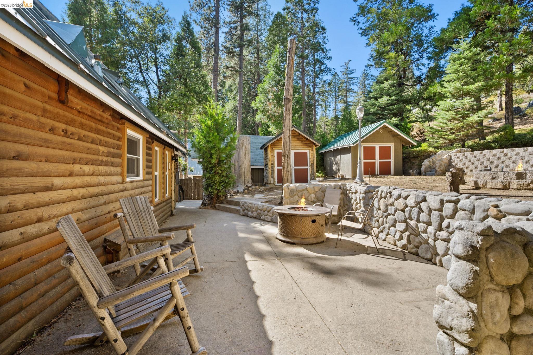 25972 Long Barn Road Long Barn, CA 95335 - Photo 30 of 36 Exterior concrete patio, stone retaining walls, and a fire pit.