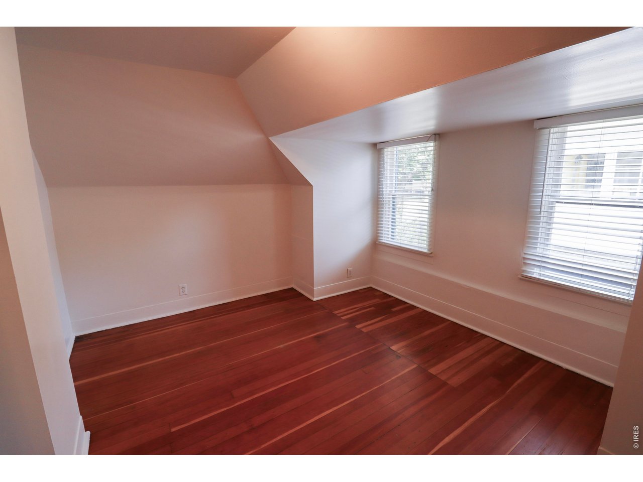 608 South Howes Street Fort Collins, CO 80521 - Photo 23 of 28 a view of an empty room with wooden floor and a window