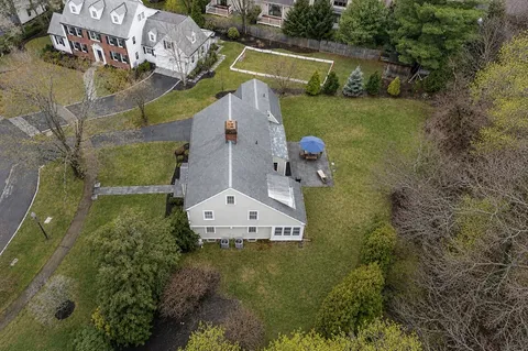 an aerial view of lake and residential houses with outdoor space