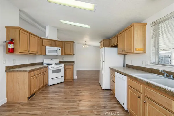 a kitchen with stainless steel appliances a refrigerator and a stove top oven