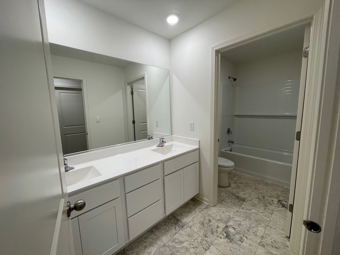 10 International Way Joliet, IL 60421 - Photo 13 of 32 a bathroom with a sink a toilet and shower