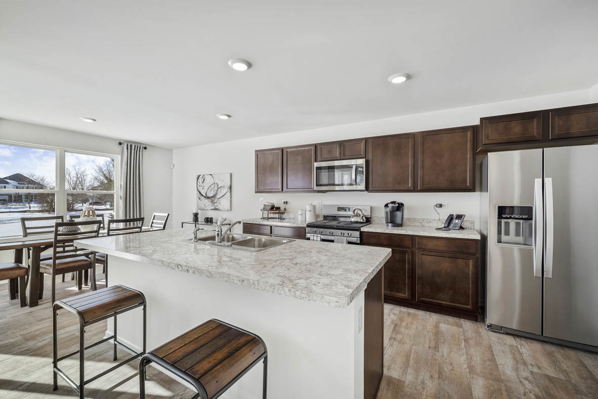 10 International Way Joliet, IL 60421 - Photo 14 of 32 a kitchen with stainless steel appliances granite countertop a stove refrigerator sink and cabinets