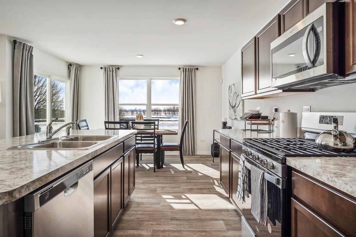 10 International Way Joliet, IL 60421 - Photo 16 of 32 a kitchen with stainless steel appliances granite countertop a sink stove and cabinets