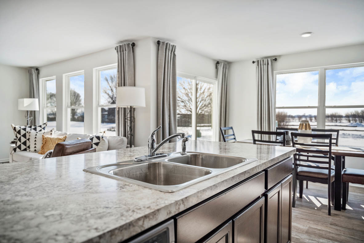 10 International Way Joliet, IL 60421 - Photo 17 of 32 a kitchen with a sink a counter and chairs