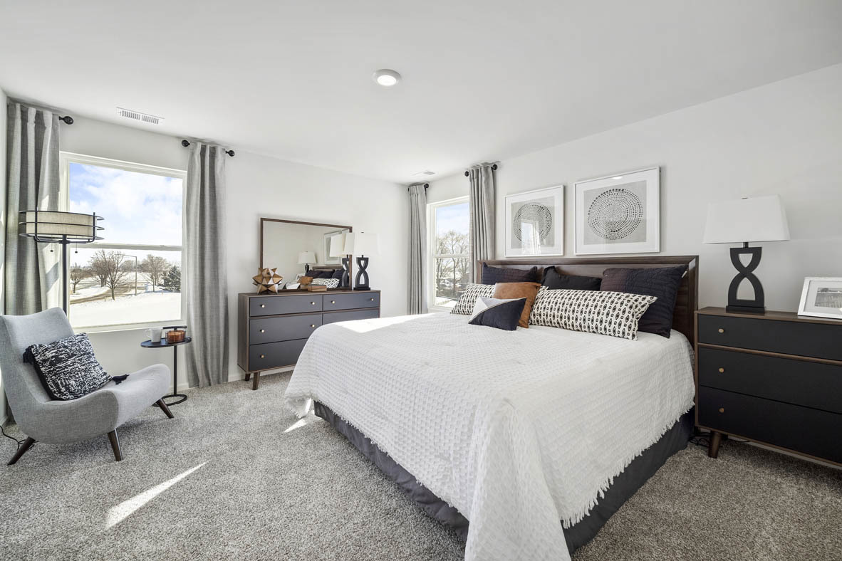 10 International Way Joliet, IL 60421 - Photo 24 of 32 a bedroom with a bed and wooden floor