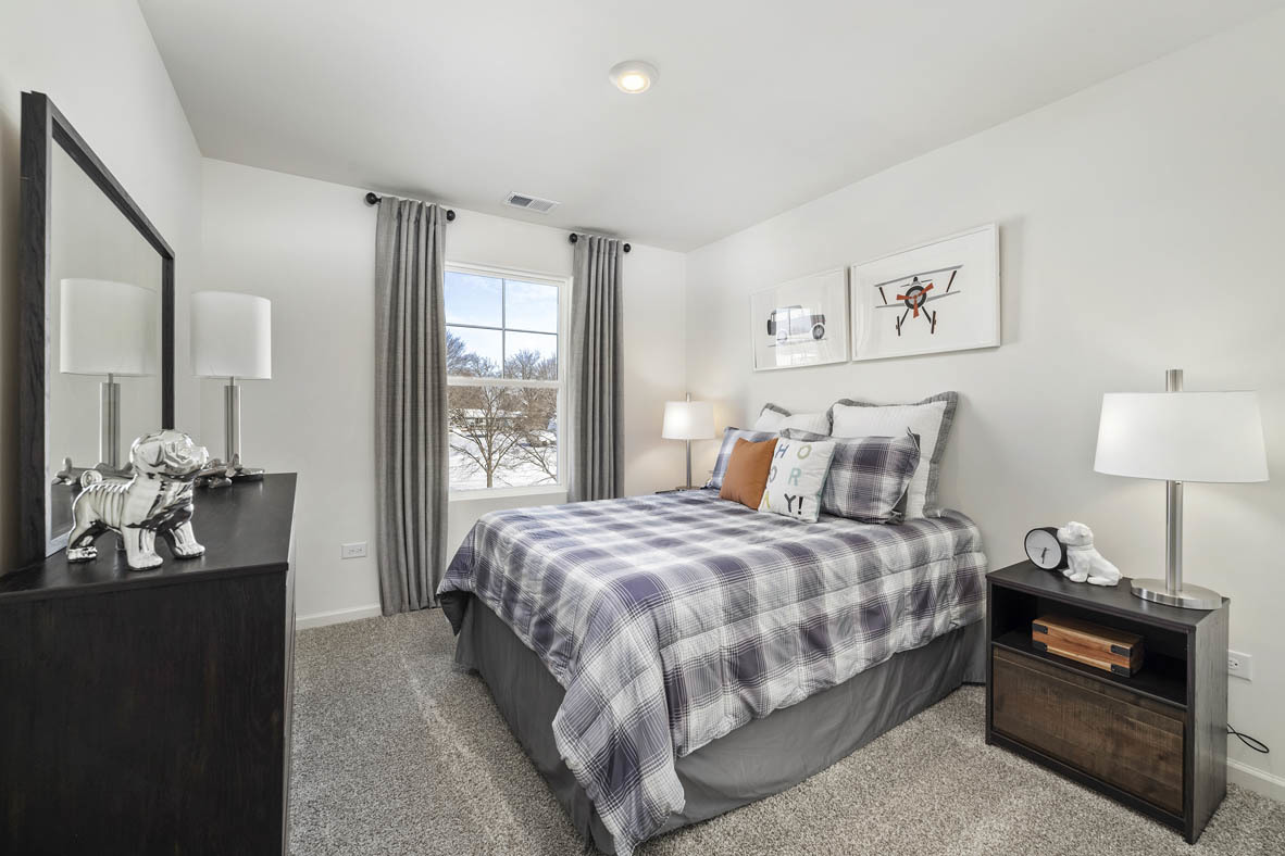 10 International Way Joliet, IL 60421 - Photo 27 of 32 a bedroom with a bed and wooden floor