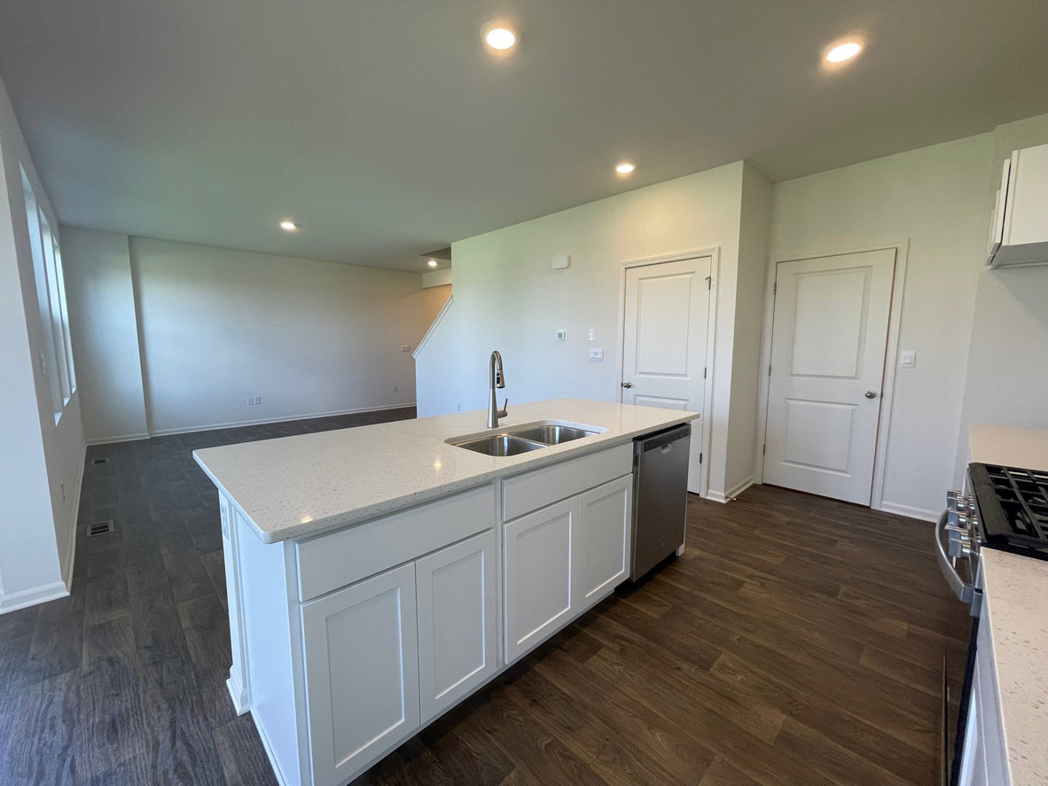 10 International Way Joliet, IL 60421 - Photo 3 of 32 a kitchen with a sink and wooden floor