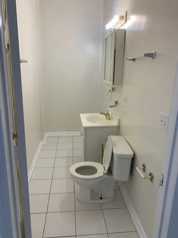 a bathroom with a sink a toilet a mirror and vanity