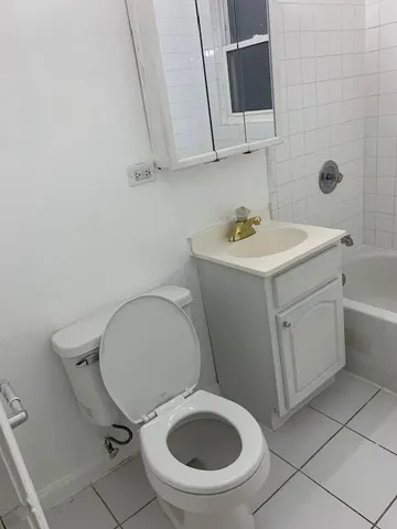 a bathroom with a sink toilet and a mirror