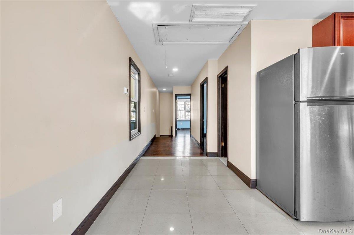 95-68 115th Street Queens, NY 11419 - Photo 9 of 28 Hallway with light tile patterned floors, attic access, and recessed lighting